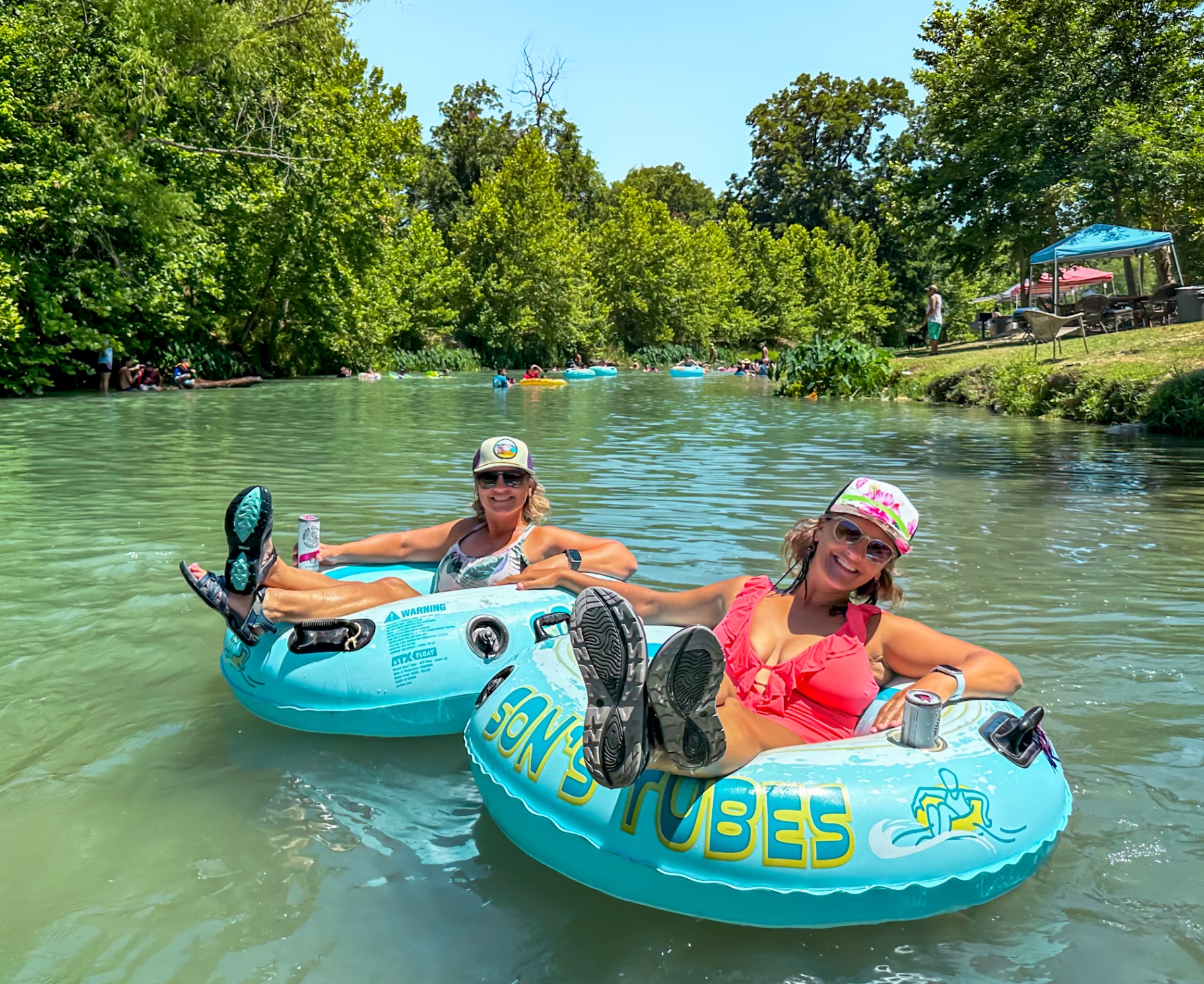 Family enjoying San Marcos River tubing at Son's River Ranch