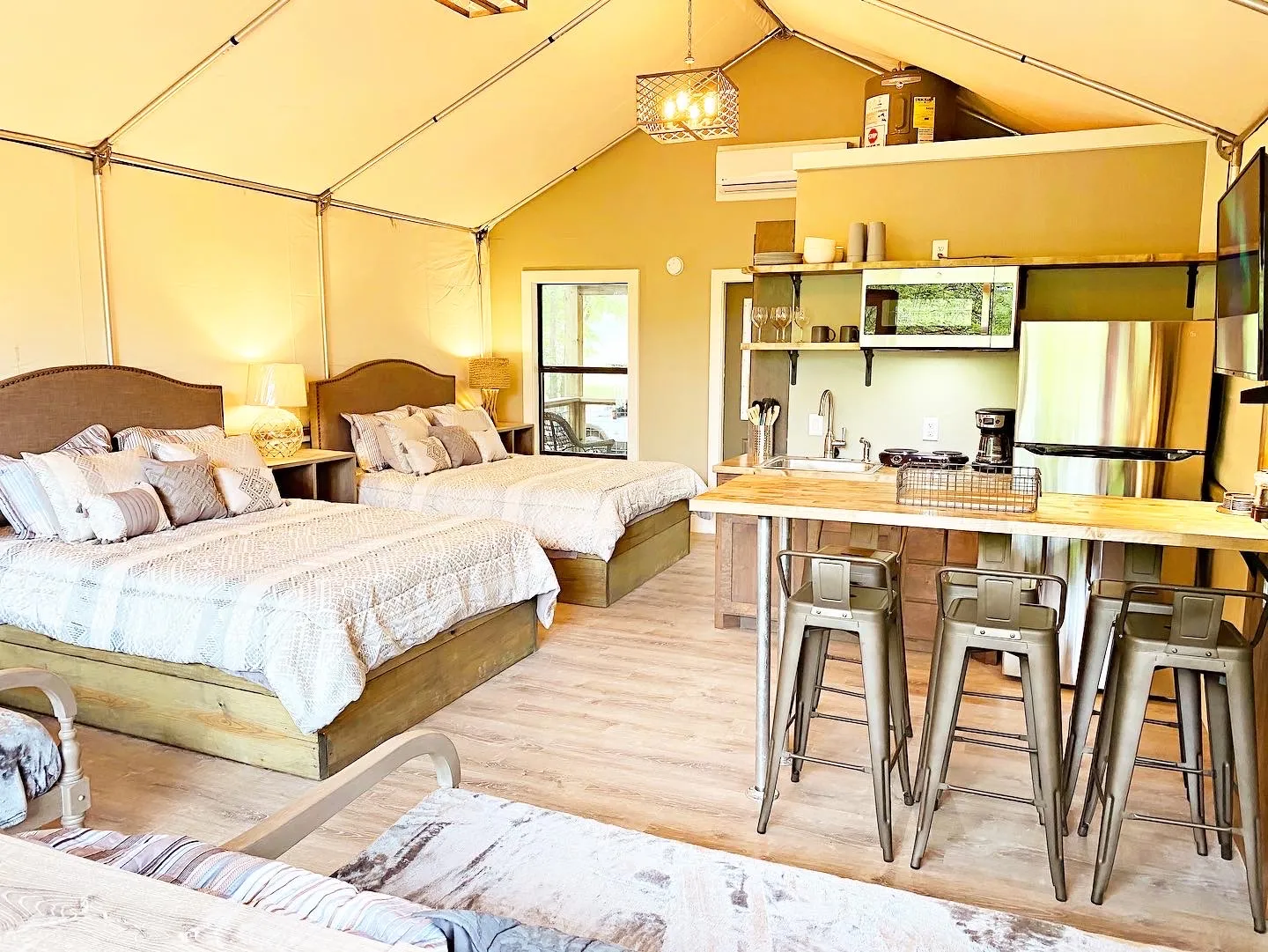 Safari tent interior with beds and kitchen