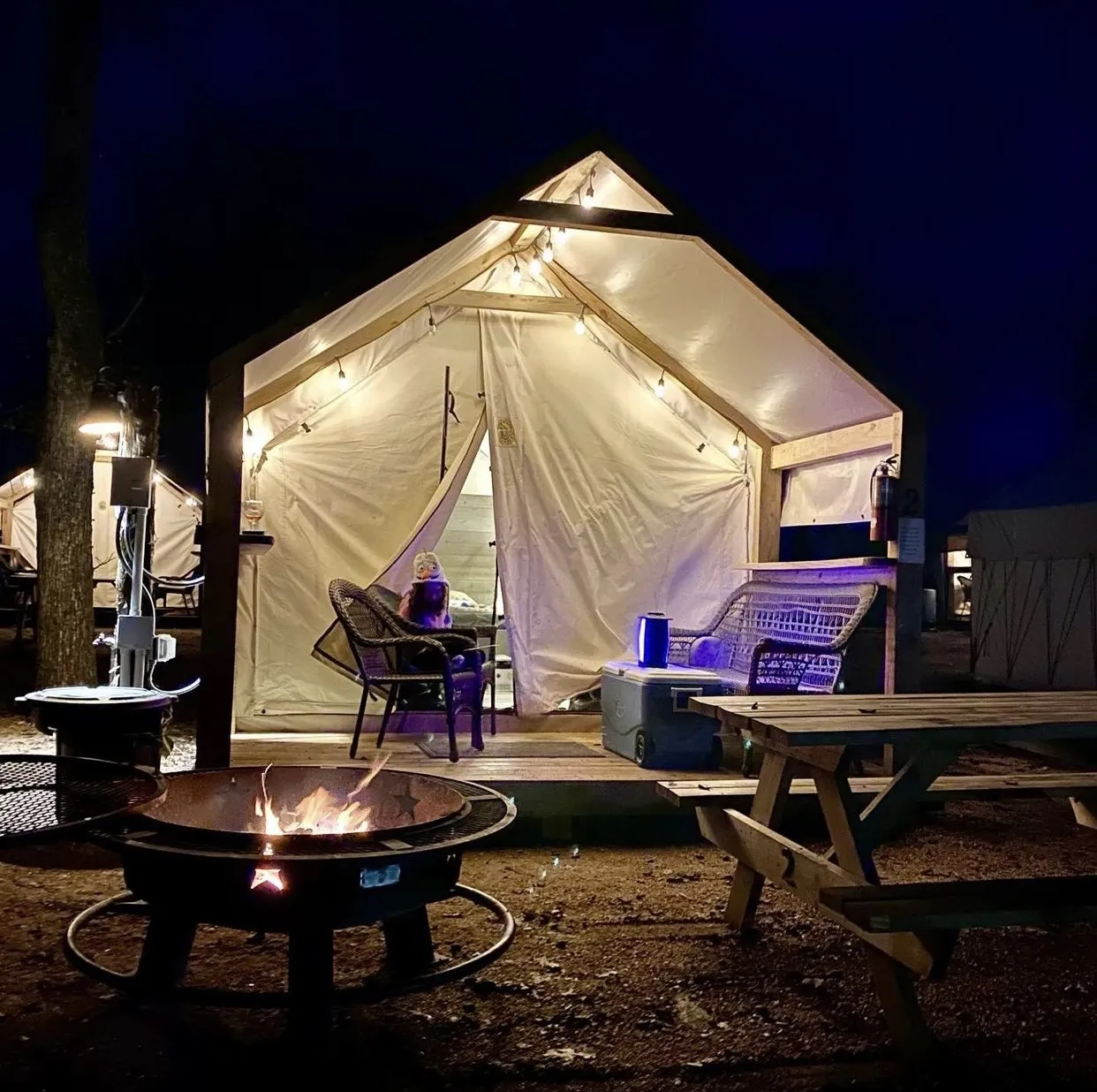 Glamping Cabin at night with fire pit
