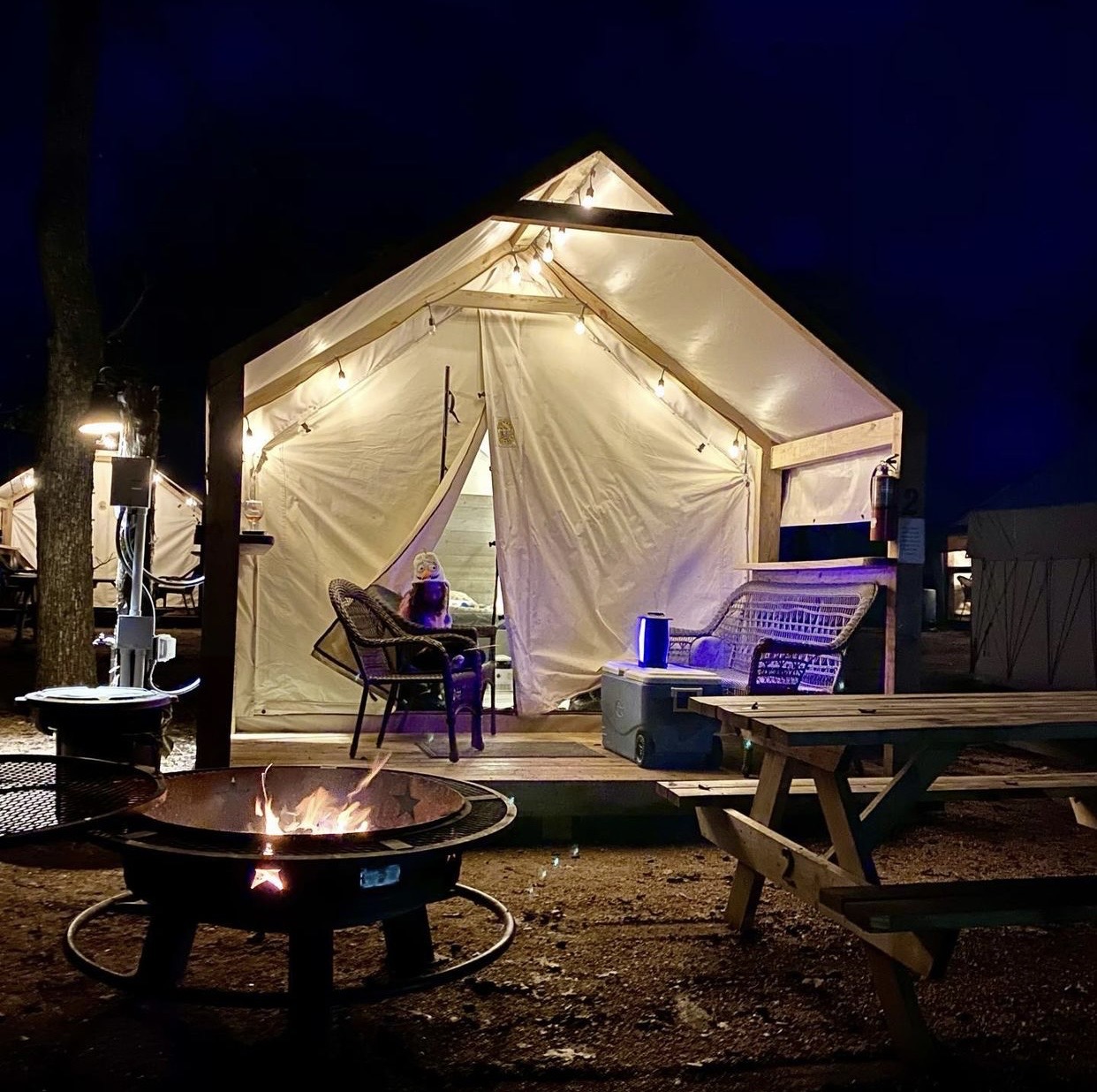 Glamping Cabin at night with fire pit