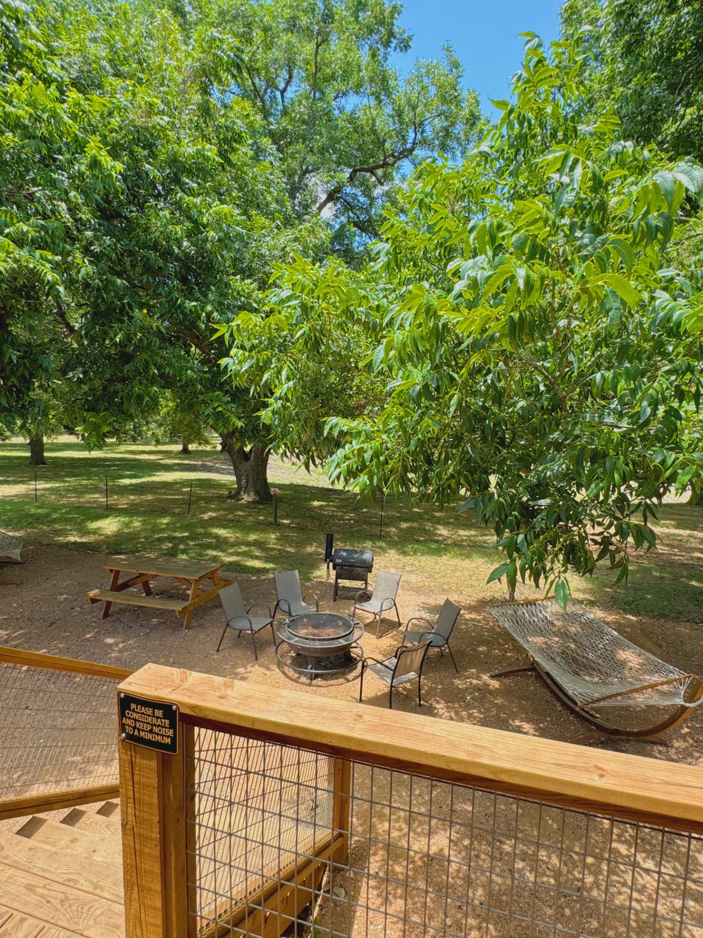 Safari Cabin outdoor area with firepit and hammock
