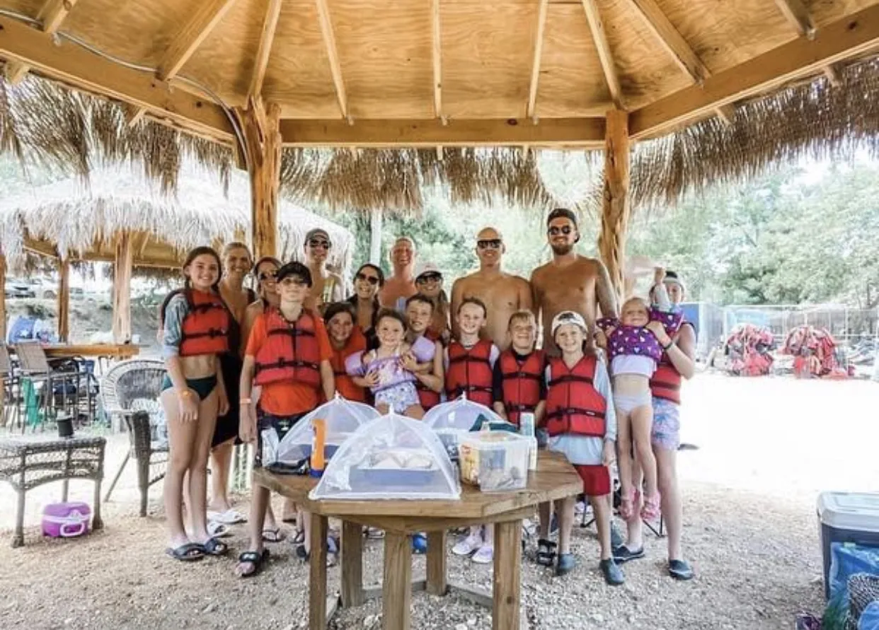 Large family group in life jackets at cabana