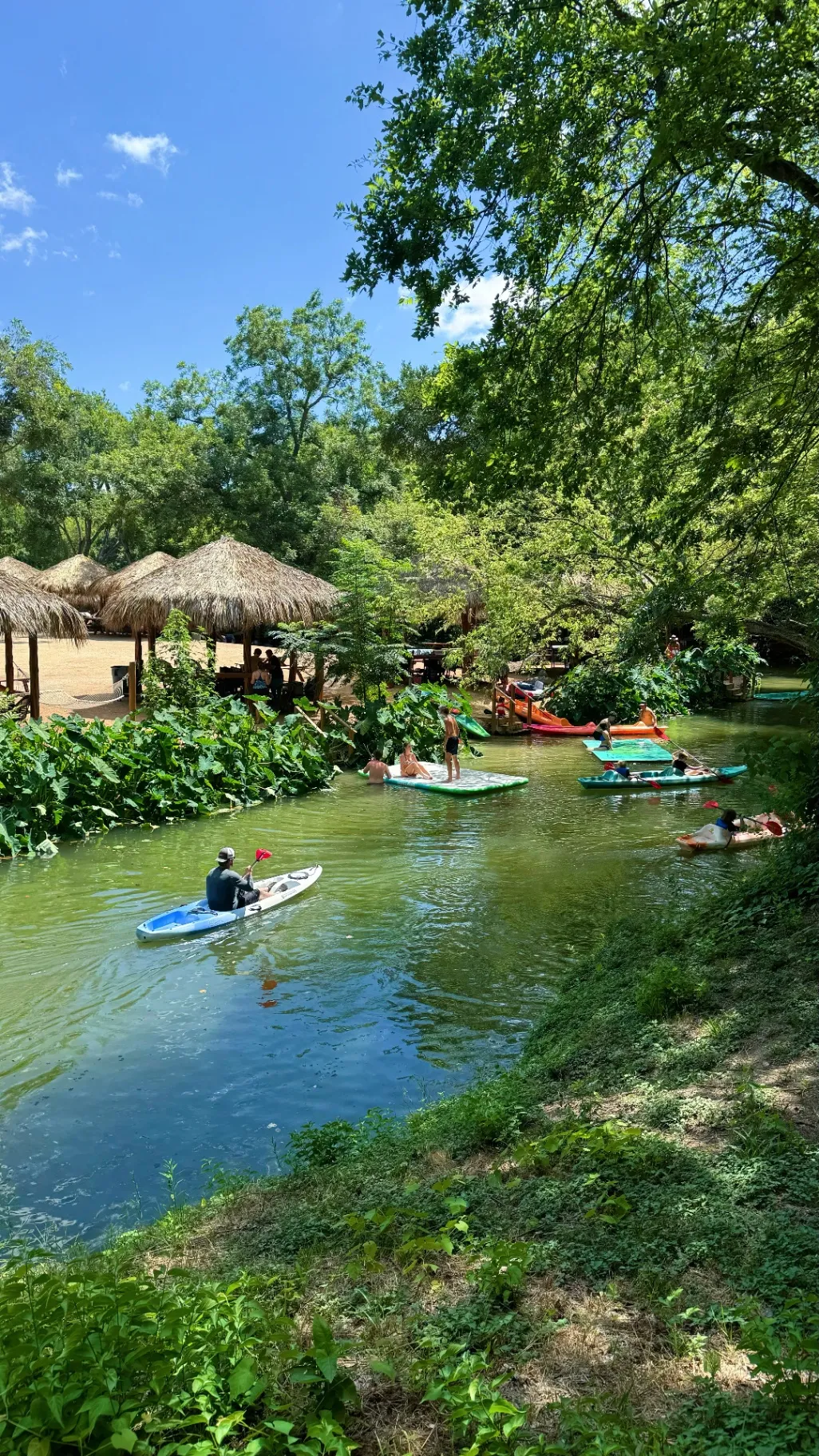 Kayakers and paddleboarders enjoying a family fun day near San Antonio