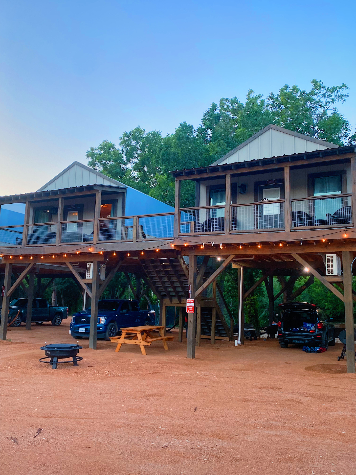 Waterfront Cabins at dusk with firepit