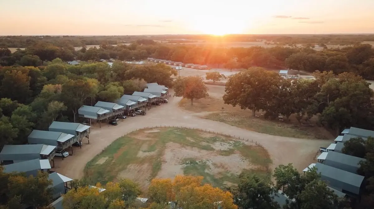 Aerial sunset view of safari cabins and property