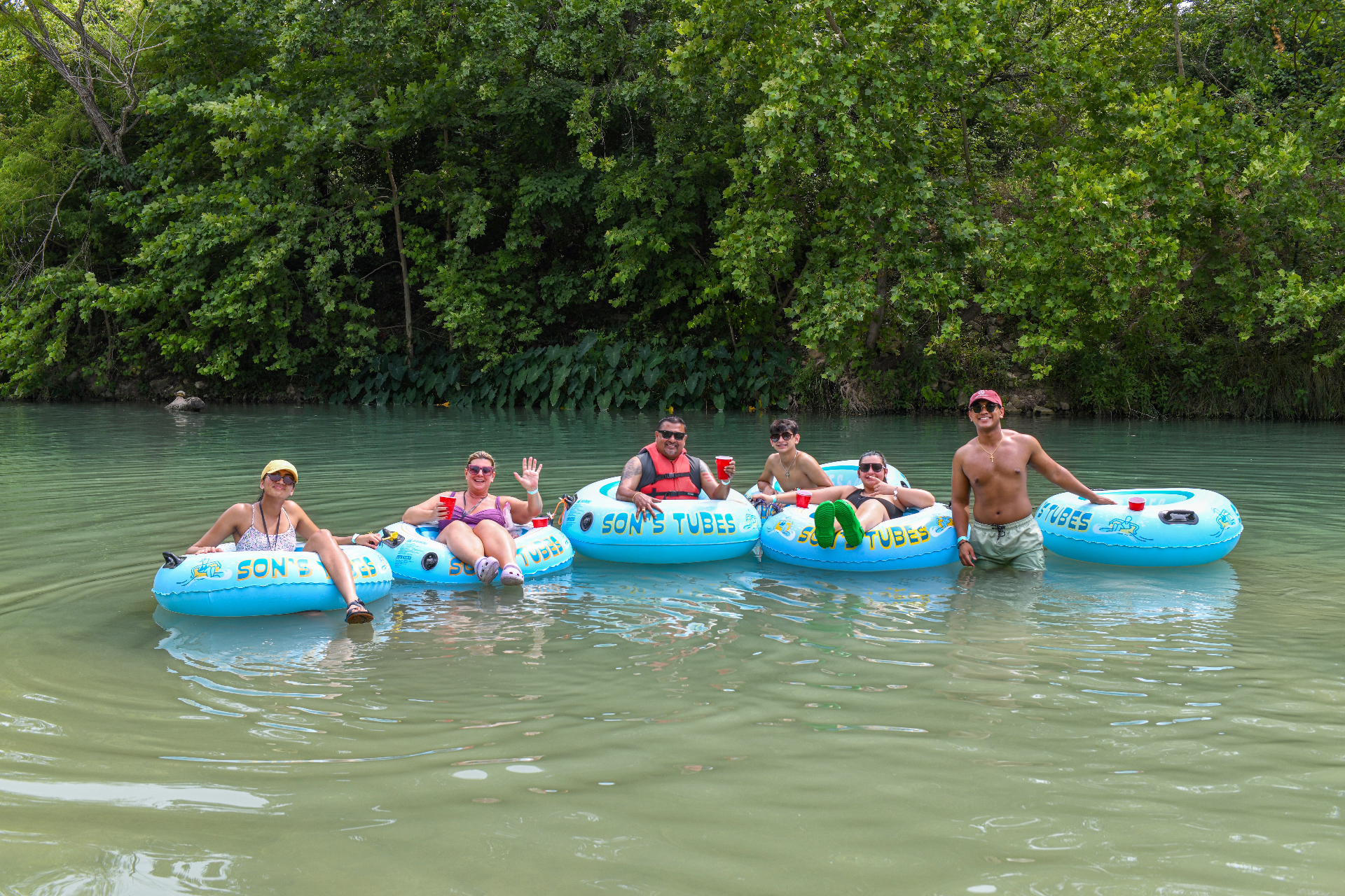 Family enjoying San Marcos River tubing at Son's River Ranch